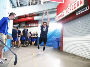 Wolves hopeful Mel Melconian participates in the long jump during  fitness testing as Brandon Grace, assistant equipment manager, looks on during Wolves training camp in Sudbury, Ont. Gino Donato/Sudbury Star/Postmedia Network