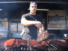 Ribber George Sakellis of Smokehouse Bandits puts sauce on ribs at  Downtown Sudbury Ribfest. Gino Donato/Sudbury Star/Postmedia Network