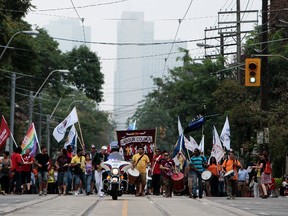 Thousands of unionized workers make their way along Queen St. during the annual Labour Day parade in Toronto on September 2, 2013. Dave Abel/Toronto Sun/Postmedia Network