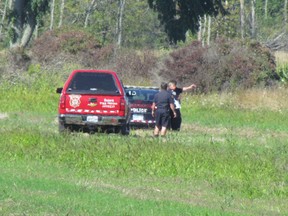 Sarnia firefighters and police officers are shown in a field north of London Line on Saturday September 3, 2016 in Sarnia, Ont. A man died Saturday when a  small airplane he was the lone occupant of crash near the 2300 block of London Line, at approximately 11:45 a.m.
Paul Morden/Sarnia Observer/Postmedia Network