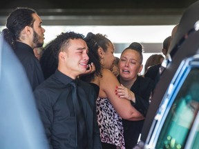 Jerome Smith by the hearse as he cries after the funeral for slain grandmother Peggy Smith at Giffen-Mack Funeral Home in Toronto, Ont. on Saturday September 3, 2016. Smith was shot and killed in the Riverdale neighbourhood of Toronto.  Ernest Doroszuk/Toronto Sun/Postmedia Network