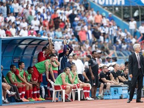 Canadian manager Benito Floro watches from the sidelines during Friday's game in Honduras. (AP)