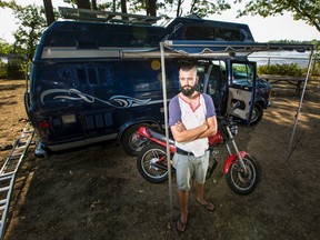 Simon Stiles stands in front of the 1992 Dodge E-350 he calls home.