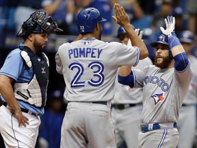 Blue Jays' Russell Martin (right) celebrates with Dalton Pompey after hitting a two-run home run off Rays pitcher Kevin Jepsen during the eighth inning in St. Petersburg, Fla., on Sunday, Sept. 4, 2016. Rays catcher Bobby Wilson (left) looks on. (Chris O'Meara/AP Photo)