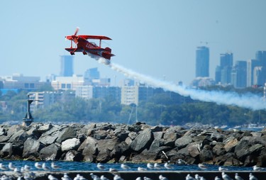 Aerial acrobat Mike Wiskus in his Lucas Oil Pitts special biplane perfumes at the 67th annual Canadian International Air Show (CIAS) soared over Lake Ontario and the CNE on the Labour Day weekend.   Sunday September 4, 2016. Jack Boland/Toronto Sun/Postmedia Network