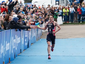 Jonathan Brownlee of Great Britain greets the audience as he prepares to finish first during the Elite Men's race at the ITU World Triathlon Edmonton at Hawrelak Park in Edmonton, Alta., on Sunday, Sept. 4, 2016.