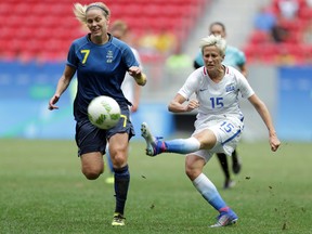 Megan Rapinoe (right), seen here playing for the U.S. against Sweden during the 2016 Rio Olympics, took a knee during the national anthem before playing in a NWSL game on Sunday in Chicago. (Eraldo Peres/AP Photo)