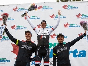 First place winner Bauke Mollema, centre, is flanked by second place winner Andzs Flaksis, left, and third place winner Robin Carpenter, right, during Stage 4 of the Tour of Alberta at Hawrelak Park in Edmonton, Alta., on Sunday, Sept. 4, 2016.