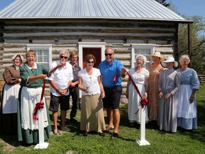 Sheila Eagen, president of the Friends of Ameliasburgh Heritage Village, cuts the ribbon celebrating the re-opening at the log cabin in the Ameliasburgh Heritage Village on Sunday September 4, 2016 in Prince Edward County, Ont. 


Emily Mountney-Lessard/Belleville Intelligencer/Postmedia Network