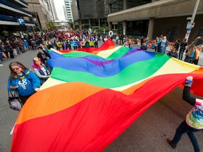 A giant pride flag is walked through the Calgary Pride Parade in the city's downtown core on Sunday, Sept. 4, 2016. (Lyle Aspinall/Postmedia Network)