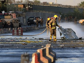 Afghan firefighters work at the site of suicide attack near Afghanistan's defence ministry in Kabul, Afghanistan, Monday, Sept. 5, 2016. (AP Photo/Rahmat Gul)