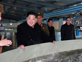 North Korean leader Kim Jong Un (C)  is seen in a file photo.   (Photo credit should read KNS/AFP/Getty Images)