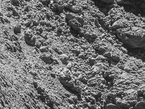 The photo released by European Space Agency ESA on Monday, Sept. 5, 2016 shows a photo of the comet lander Philae in a crack on the right side of a photo taken by Rosetta's OSIRIS narrow-angle camera on Sept. 2, 2016 from a distance of 2.7 km of the Comet 67P/Churyumov–Gerasimenko. (ESA/Rosetta/MPS for OSIRIS via AP)
