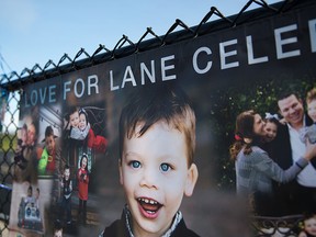 In this Saturday, Sept. 3, 2016, photo, banners with a collage of photos of Lane Graves and his family hang on display with blue balloons and ribbons for a Love for Lane Celebration on what would have been his third birthday at Elkhorn South High School in Omaha, Neb. (Rebecca S. Gratz/Omaha World-Herald via AP)