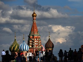 People walk along the Red Square toward to St Basil's Cathedral (background) in Moscow on July 11, 2016.  ( VASILY MAXIMOV/AFP/Getty Images)