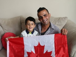 James Akam is pictured with his son, Bahroz. Akam worked as an interpreter for Canada in Afghanistan and fled the country  -- nleaving his family behind -- when  Canadian Forces.  After escaping to Europe he made his way to Canada and was finally reunited with his wife and son in Calgary in June. (POSTMEDIA NETWORK)