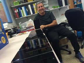 Wade Gregg, the principal at Queenston School, displays iPad minis elementary students will have access to when they go back to school Tuesday. (DAVID LARKINS/Winnipeg Sun/Postmedia Network)