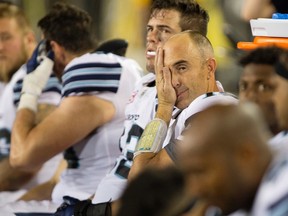 Argonauts quarterback Ricky Ray rubs his face on the bench during second-half CFL action in Hamilton, Ont., on Monday, Sept. 5, 2016. (Peter Power/The Canadian Press)