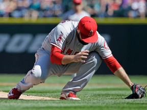 Angels starting pitcher Matt Shoemaker collapses onto the field after being hit by a line drive in Seattle on Sunday, Sept. 4, 2016. (Elaine Thompson/AP Photo)