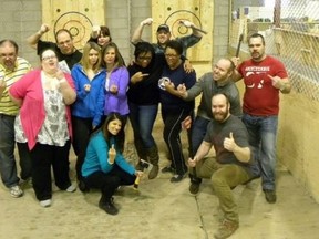 As is common among those who toss axes at targets for recreation, teachers from Markham District High School posed together and collectively flipped the bird. (FACEBOOK)