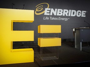 Enbridge company logos on display at the company's annual meeting in Calgary, Thursday, May 12, 2016. Enbridge Inc. of Calgary plans to buy Houston-based Spectra Energy Corp. for stock worth $37 billion. The combination of the two pipeline companies would create a North American energy infrastructure giant, to be called Enbridge Inc. and headquartered in Calgary. (THE CANADIAN PRESS/Jeff McIntosh)