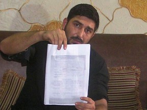 This photograph taken on July 28, 2016 shows Mukhtar Kazam, the husband of late British woman Samia Shahid, as he displays her post-mortem report during a press conference in Rawalpindi. Kazam has called for the U.K. and Pakistani governments to ensure his wife received justice, as he sought to keep the spotlight on so-called "honour" killings. (HABIB SHAIKH/AFP/Getty Images)