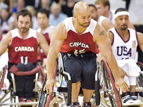 Canada's forward David Eng (15) chases down a loose ball against The United States during second-half men's gold medal wheelchair basketball action at the Parapan Am Games in Toronto on Saturday, Aug. 15, 2015. Eng will carry Canada's flag into the opening ceremony of the Rio Paralympics. THE CANADIAN PRESS/Nathan Denette