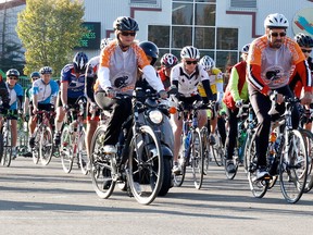 Cyclists leave the starting line at the Omniplex for the DV100.