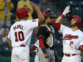 Winnipeg Goldeyes third baseman Wes Darvill (left) high-fives DH Adam Heisler after Heisler hit a two-run home run in the bottom of the fifth inning against the Fargo-Moorhead RedHawks on Saturday. The Goldeyes open their best-of-five playoff series with St. Paul on Wednesday at Shaw Park. (Kevin King/Winnipeg Sun)