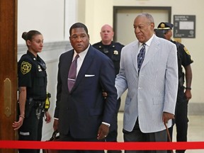 Bill Cosby, right, is lead into Courtroom A in the Montgomery County Courthouse in Norristown, Pa., by one of his aides on Tuesday, Sept. 6, 2016, for a pre-trial conference in his sexual assault case and to set a trial date.  (Michael Bryant/The Philadelphia Inquirer via AP)