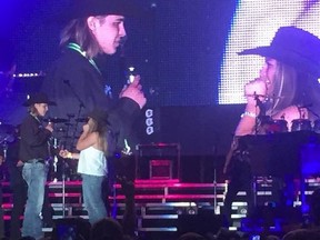 Brady Kram, left, proposes to Felicity Hilliard on the main stage of Lucknow’s Music in the Fields in front of thousands of people during the Aug. 25-27, 2016 event. (Darryl Coote/Kincardine News and Lucknow Sentinel)