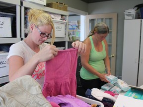 Heather Taylor (left) sorts clothes as Tanya Barrett (right) organizes diapers for the care closet at Beginnings Family Services Pregnancy Care Centre on Tuesday, Sept. 6, 2016. The organization is celebrating 25 years in Woodstock this year. (MEGAN STACEY, Sentinel-Review)