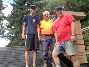 Three generations of the Fabbro men — Ross, Pietro and Mario — stand on a roof of a home in Kingston on Tuesday. (Patrick Kennedy/The Whig-Standard)