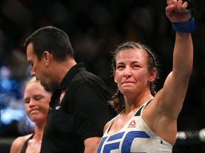 Miesha Tate (right) says she carried a little girl, who broke her arm while hiking near Las Vegas, back down the mountain. Tate posted on Facebook that she encountered the 6-year-old on Sunday on the popular Mary Jane Falls trail of Mount Charleston, about 40 miles northwest of Las Vegas. (Eric Jamison/AP Photo/Files)