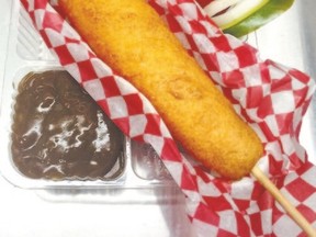 Billie Campbell will be inside the west annex at this year?s Western Fair offering a new version of the Quebec classic, a poutine corn dog with gravy, a hot dog skewered with cheese and mashed potato, battered and deep fried with gravy on the side for $8. (MORRIS LAMONT, The London Free Press)