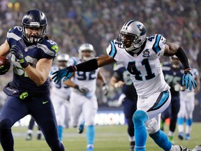 Seahawks tight end Luke Willson (left) runs past Panthers strong safety Roman Harper (41) to score on a 25-yard touchdown pass during second half of an NFL playoff game in Seattle on Jan. 10, 2015. Willson will likely start for the Seahawks as the team waits for starter Jimmy Graham to be fully healthy. (Ted S. Warren/AP Photo/Files)