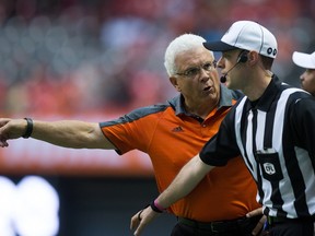 Lions head coach Wally Buono (left) protests a call to an official during the first half of a CFL game against the Stampeders in Vancouver on Aug. 19, 2016. (Darryl Dyck/The Canadian Press)