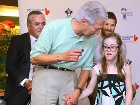 Dr. John Laporta, chief executive of Thames Valley Children?s Centre, introduces Cameron Hardman, 12, child ambassador to the Freedom 55 Financial Championship at the centre on Tuesday. Looking on is Mike Cuneen of Freedom 55 Financial, left, and NHL player Brandon Prust. (MORRIS LAMONT, The London Free Press)