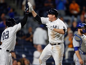 Yankees' Chase Headley celebrates hitting a two-run home run with Eric Young Jr. (48) as Blue Jays catcher Russell Martin looks away during eighth inning MLB action in New York on Tuesday, Sept. 6, 2016. (Adam Hunger/AP Photo)