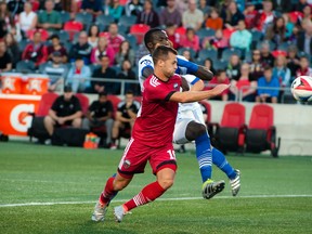 Fury FC’s Thomas Stewart (left) battles an FC Edmonton player for the ball at TD Place. (Ashley Fraser/Postmedia Network)