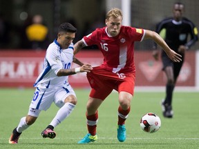 El Salvador's Jaime Alas (left) pulls on the shorts of Canada's Scott Arfield as they vie for the ball during second half FIFA World Cup qualifying action in Vancouver on Tuesday, Sept. 6, 2016. (Darryl Dyck/The Canadian Press)