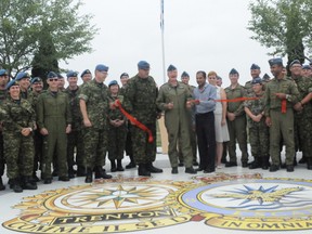 Ernst Kuglin/The Intelligencer
8 Wing/CFB Trenton Commander Col. Colin Keiver cuts the ribbon Wednesday morning to officially open the 8 Wing Heritage Park, located in front the Officer’s Mess. The park tells the story of Canada’s largest air force base.