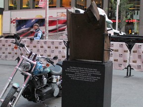 A motorcycle sits next to a piece of steel beam from the south tower from the World Trade Center towers in New York on Tuesday Sept. 6, 2016. Fifteen years after the terrorist attack on the World Trade Center towers in New York, the American city continues to thank the people of Gander, Newfoundland and Labrador, for opening their arms to thousands of stranded travellers. THE CANADIAN PRESS/HO-Stephen Siller Tunnel to Towers Foundation