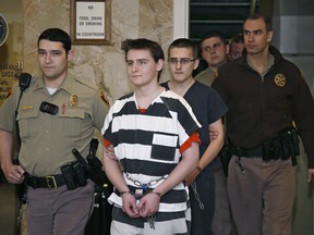 In this Tuesday, Feb. 23, 2016 file photo, Robert Bever, second from left, and Michael Bever, third from left, are escorted into a courtroom for a hearing in Tulsa, Okla. The two Oklahoma teenage brothers are charged with fatally stabbing their parents and three of their younger siblings. Robert Bever, the elder of the two, has been sentenced to life without parole after pleading guilty in the killings. (AP Photo/Sue Ogrocki, File)