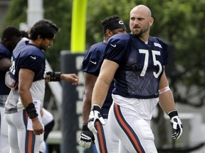 Chicago Bears offensive tackle Kyle Long warms up during NFL football training camp in Foxborough, Mass. (AP Photo/Elise Amendola, File)