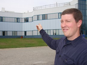 Hospital maintenance worker Peter Ryan points to one of the aging air conditioning units on top of the Timmins and District Hospital which is in need of about $2 million in roof repairs.