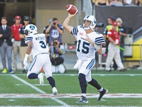 Argos QB Ricky Ray gets off a pass in the first half on Monday — when he wasn’t being pressured by the Ticats. (Peter Power, The Canadian Press)