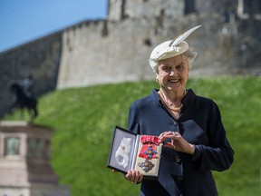 Actress Angela Lansbury poses with her Dame Commander (DBE) medal given to her by Queen Elizabeth II at an Investiture ceremony at Windsor Castle on April 15, 2014, in Berkshire, England. (Steve Parsons - WPA Pool/Getty Images)