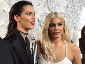 Sisters Kendall Jenner, left, and and Kylie Jenner speak to  the media at a party for their KENDALL + KYLIE collection in downtown Manhattan on Wednesday, Sept 7, 2016.  Their fashion collection includes clothing, footwear and handbags. (AP Photo/Jocelyn Noveck)