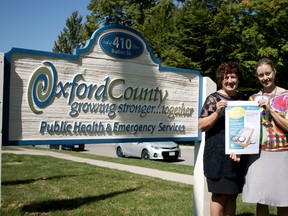 Manager of foundational standards Ruth Sanderson and Epidemiologist Hilary Caldarelli (from left to right) hold an advertisement from the Health Matters Survey that Oxford County public health launched this week. (BRUCE CHESSELL/Sentinel-Review)